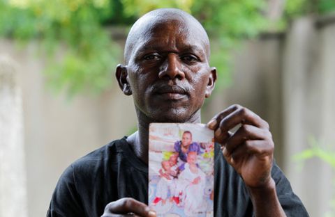 Steven Mwiti holds a photograph of his late wife Joan Bahati. Mwiti was too distraught to go identify the bodies of his wife and six children among the corpses of dozens of cult members. "My children are gone. The children who have been rescued, I went and had a look and I did not see my children," Mwiti said as he waved a photo of his wife and four of the children. He has been carrying the fading, dog-eared photo in a plastic bag for the last six months or so as he searched for his young ones. REUTERS/Monicah Mwangi